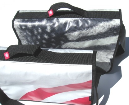 A recycled laptop bag made from Powershop's Electricity vs Power billboard campaign.